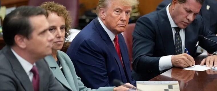 Trump in court, flanked by his lawyers. Photo credit: Getty Images